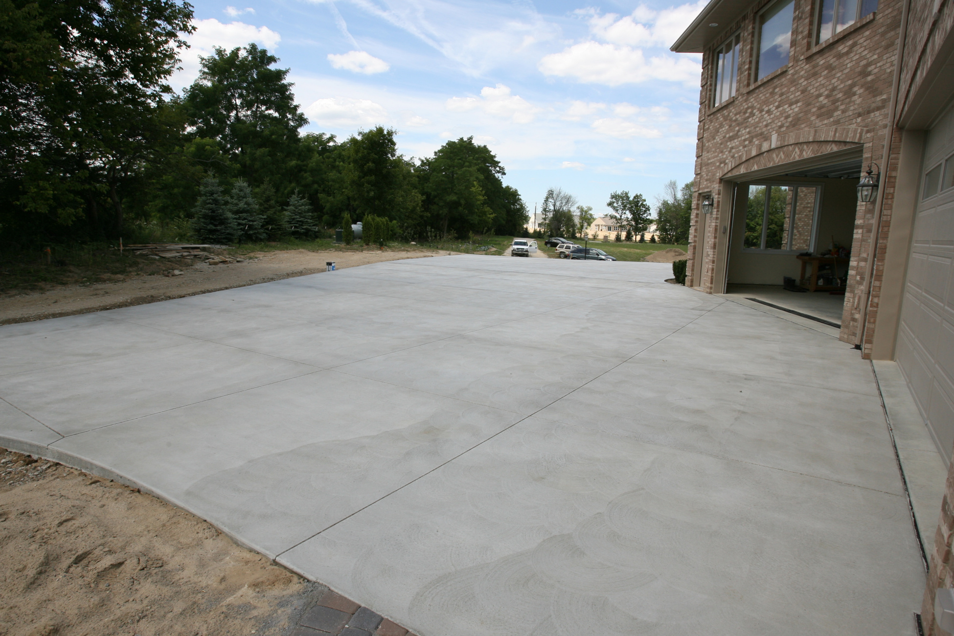 Plain concrete driveway with brushed swirled texture