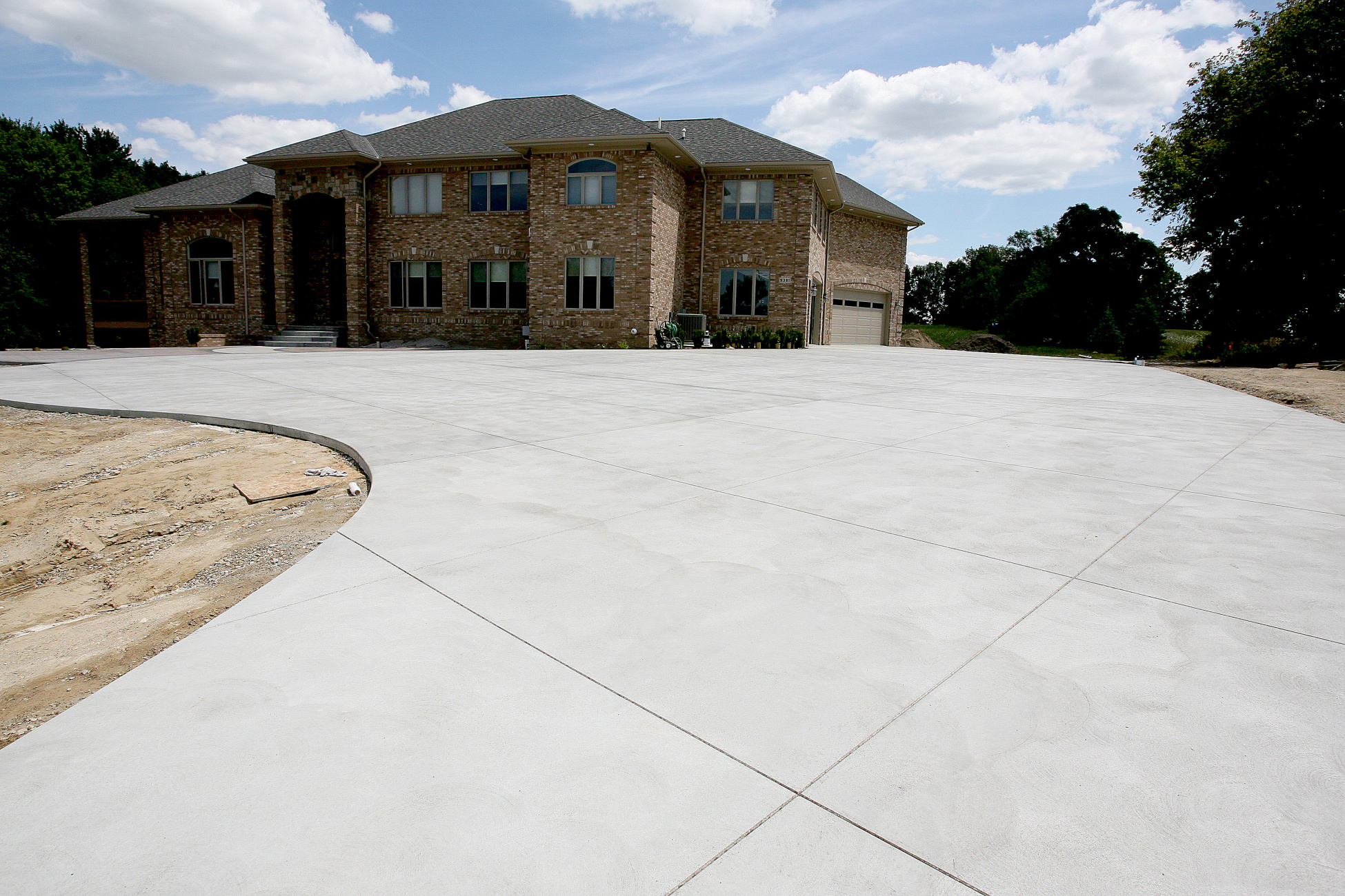 Plain concrete driveway with brushed swirled texture